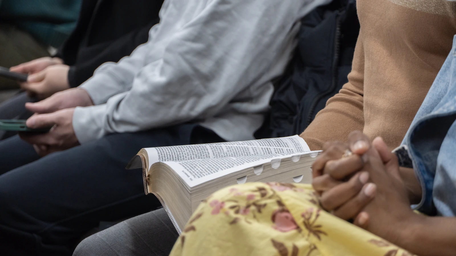 Adults gathered with an open Bible during faith formation.